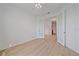 Spacious bedroom featuring neutral colored walls, wood floors, and large glass paneled doors at 6266 Buckingham St, Sarasota, FL 34238
