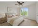 Bright bedroom with large window, neutral decor, and wood-look flooring at 6266 Buckingham St, Sarasota, FL 34238