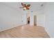 Spacious bedroom with wood floors, ceiling fan, bathroom, and closet access at 6266 Buckingham St, Sarasota, FL 34238