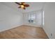 Bedroom with wood floors, ceiling fan, and natural light from a large window at 6266 Buckingham St, Sarasota, FL 34238