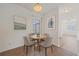 Cozy breakfast nook with a round table, four chairs, and natural light at 6266 Buckingham St, Sarasota, FL 34238