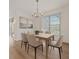 Light and bright dining room with chandelier and large window at 6266 Buckingham St, Sarasota, FL 34238