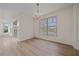 Bright dining room features chandelier and large window with view at 6266 Buckingham St, Sarasota, FL 34238