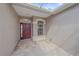 Inviting front entrance showcasing a tile floor, a red door and complementing neutral walls at 6266 Buckingham St, Sarasota, FL 34238