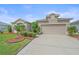 Charming single-story home with well-manicured landscaping, a spacious driveway, and an attached garage at 6266 Buckingham St, Sarasota, FL 34238
