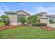 Charming single-story house featuring lush landscaping, mulch accents and mature landscaping at 6266 Buckingham St, Sarasota, FL 34238