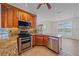 Well-lit kitchen with granite counters, stainless steel appliances, and breakfast bar at 6266 Buckingham St, Sarasota, FL 34238