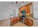 Kitchen area featuring granite counters, wood cabinets and stainless steel appliances at 6266 Buckingham St, Sarasota, FL 34238
