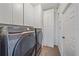 Laundry room with white cabinetry and newer model washer and dryer at 6266 Buckingham St, Sarasota, FL 34238