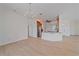 Open-concept living room with hardwood floors, chandelier, and views into the kitchen at 6266 Buckingham St, Sarasota, FL 34238