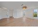 Bright, open living room with light wood floors, front door, and access to other rooms at 6266 Buckingham St, Sarasota, FL 34238