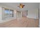 Spacious living room features a ceiling fan, light wood flooring, and open access to other rooms at 6266 Buckingham St, Sarasota, FL 34238