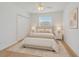 Nicely staged primary bedroom features wood flooring, neutral decor, and a ceiling fan at 6266 Buckingham St, Sarasota, FL 34238