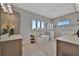 Bright bathroom featuring dual sinks, a soaking tub, and a glass enclosed shower at 6317 Turtle Grass Dr, Bradenton, FL 34210