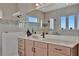 Stylish bathroom includes a contemporary vanity with a sleek countertop, and a large mirror at 6317 Turtle Grass Dr, Bradenton, FL 34210