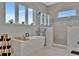 Modern bathroom featuring a soaking tub, walk-in shower, and ample natural light from the windows at 6317 Turtle Grass Dr, Bradenton, FL 34210