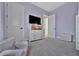 This bedroom offers a comfortable lounge chair, a stylish dresser, and an open doorway at 6317 Turtle Grass Dr, Bradenton, FL 34210