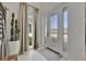 An elegant foyer with a decorative cactus, neutral color palette, and tile flooring at 6317 Turtle Grass Dr, Bradenton, FL 34210
