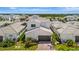 Aerial view of a home with a two-car garage and lush landscaping at 6317 Turtle Grass Dr, Bradenton, FL 34210