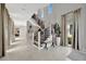 A stylish entryway featuring a two-story ceiling, open staircase, and tile floors at 6317 Turtle Grass Dr, Bradenton, FL 34210
