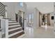 Grand foyer with modern staircase, high ceilings, and lots of natural light at 6317 Turtle Grass Dr, Bradenton, FL 34210