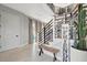A modern foyer with open staircase, neutral palette, and decor at 6317 Turtle Grass Dr, Bradenton, FL 34210