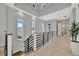Light-filled hallway with tray ceilings, white trim, and many windows allowing for ample natural light at 6317 Turtle Grass Dr, Bradenton, FL 34210