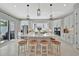 Bright kitchen with white cabinets, large island with seating, and modern appliances perfect for entertaining at 6317 Turtle Grass Dr, Bradenton, FL 34210