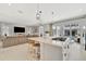 Open concept with a stylish kitchen island, gas cooktop, and seamless flow to the inviting living room and pool view at 6317 Turtle Grass Dr, Bradenton, FL 34210