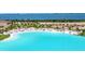 Scenic view of turquoise lagoon water with a pristine white sand beach, lined with palm trees at 6317 Turtle Grass Dr, Bradenton, FL 34210