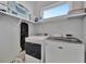 Laundry room with modern washer and dryer units and plenty of storage space at 6317 Turtle Grass Dr, Bradenton, FL 34210
