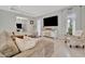 Bright living room featuring tile floors, a comfortable sectional sofa, and a large television for relaxing evenings at 6317 Turtle Grass Dr, Bradenton, FL 34210