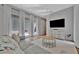 Cozy living room featuring plush seating and natural light from large windows at 6317 Turtle Grass Dr, Bradenton, FL 34210