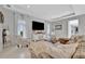 Cozy living room showcasing neutral tones, comfortable seating, and a large television for Gathering entertainment at 6317 Turtle Grass Dr, Bradenton, FL 34210