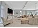 Bright living room offers ample seating and a large television, perfect for entertaining guests at 6317 Turtle Grass Dr, Bradenton, FL 34210