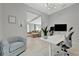 Open-concept office connects to living room, offering natural light and modern decor at 6317 Turtle Grass Dr, Bradenton, FL 34210