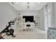 Modern office space features a Peloton bike, sleek desk, and bright natural light at 6317 Turtle Grass Dr, Bradenton, FL 34210