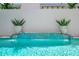 A luxurious pool with tile accents and a relaxing waterfall feature at 6317 Turtle Grass Dr, Bradenton, FL 34210