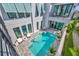Aerial view of a modern pool, patio, and outdoor seating surrounded by sleek design at 6317 Turtle Grass Dr, Bradenton, FL 34210