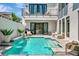 Inviting backyard pool with a sun shelf and elegant seating area at 6317 Turtle Grass Dr, Bradenton, FL 34210