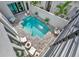 Aerial view of a modern pool, patio, and outdoor seating surrounded by sleek design at 6317 Turtle Grass Dr, Bradenton, FL 34210