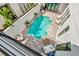 Aerial view of the private pool and patio area with outdoor seating and lush landscaping at 6317 Turtle Grass Dr, Bradenton, FL 34210
