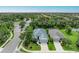 Aerial view of a charming home featuring landscaped grounds near a pond and neighborhood amenities at 6516 Palm Leaf Ct, Sarasota, FL 34243