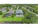 Backyard featuring lush green space, screened enclosure and pond views at 6516 Palm Leaf Ct, Sarasota, FL 34243