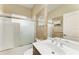 Bathroom with tiled shower-tub combination, vanity, and large mirror at 6516 Palm Leaf Ct, Sarasota, FL 34243