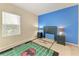 Vibrant bedroom with blue accent wall, large window, and two bedside tables at 6516 Palm Leaf Ct, Sarasota, FL 34243