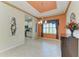 A dining room area featuring a decorative ceiling, tile flooring, and a window with elegant curtains at 6516 Palm Leaf Ct, Sarasota, FL 34243