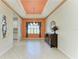 A dining room area featuring a decorative ceiling, tile flooring, and a window with elegant curtains at 6516 Palm Leaf Ct, Sarasota, FL 34243
