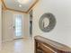 Inviting foyer with tile flooring, decorative mirror, and a glass-paneled front door at 6516 Palm Leaf Ct, Sarasota, FL 34243