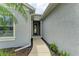 Inviting front entrance with a well-maintained walkway and neutral exterior paint at 6516 Palm Leaf Ct, Sarasota, FL 34243